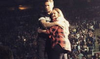 Levine hugs bruised fan at Toronto concert.